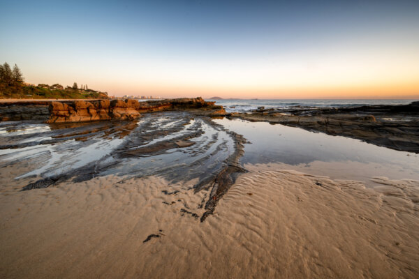 A fascinating shot of a sandy beach on background of the sunset
